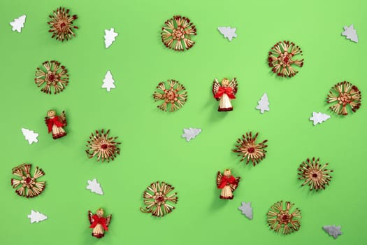 Christmas decoration made with straw on green cardboard