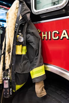 CHICAGO, ILLINOIS, USA - OCTOBER 10, 2018: The fireman's clothes by the real squad fire truck in Chicago Fire Department at the quarters of Engine Co. 5, filmed in the legendary series 'Chicago Fire' reportage
