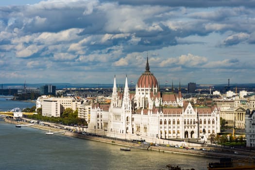 Beautiful landmark of Budapest parliament on Danube with cloudy sky.