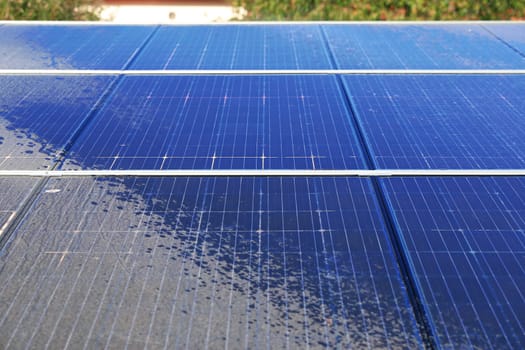 Photovoltaic system contaminated with pollen, cleaning with water, before - after effect.