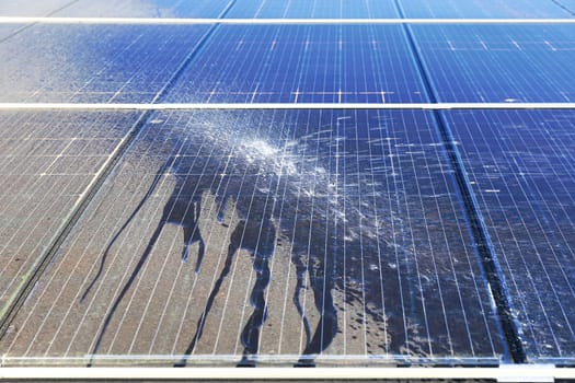 Photovoltaic system contaminated with pollen, cleaning with water, before - after effect.