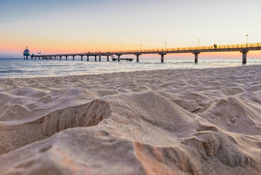 beach, drip castle, pier, bridge Zinnowitz in the sunrise, Baltic Sea island Usedom Germany