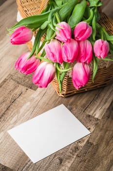 Beautiful bouquet of pink tulips and congratulations on the table