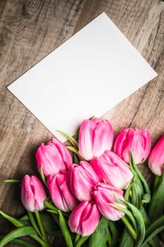 Beautiful bouquet of pink tulips and congratulations on the table