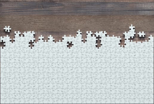Blank jigsaw puzzle missing half to finish. Concept of work not completed.