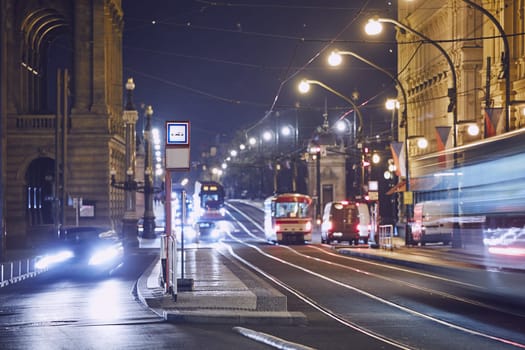 Traffic of trams and cars on the city street at night. Prague, Czech Republic.