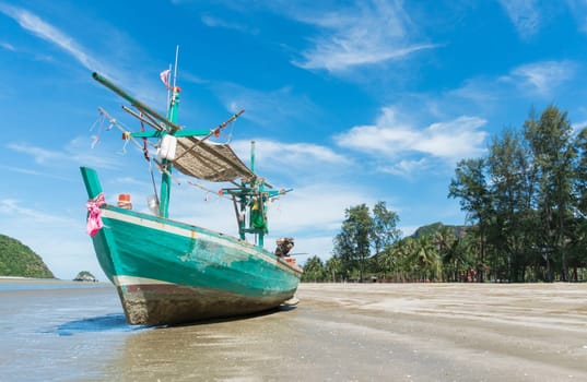 Green Fishing Boat or Fisherman Boat or Ship and blue sky and mountain or hill at Sam Roi Yod Beach Prachuap Khiri Khan Thailand. Landscape .or scenery for summer season concept