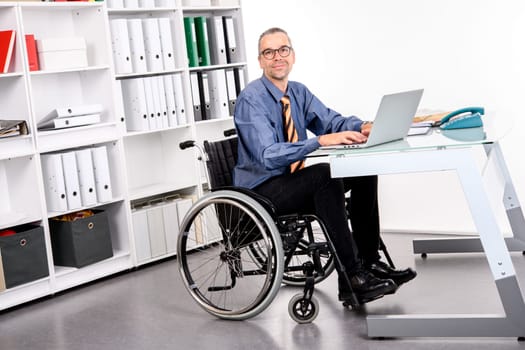 disabled business man in wheelchair working  in the office