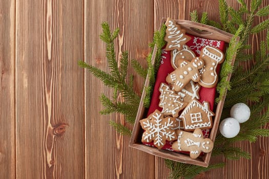 Christmas gingerbreads. Christmas decorations and handmade cookies on tray lying on the wooden background with copy space for text. Top view. Christmas and New Year.
