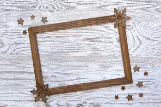 Christmas decorations with empty frame on a light wooden background with copy space for text. Top view. Christmas and New Year. Greeting card