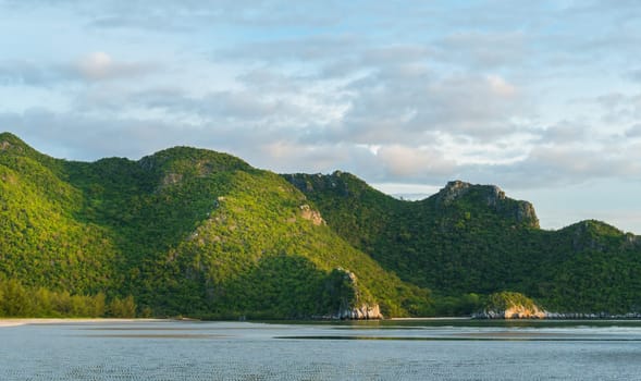 Green Rock or Stone Mountain or Hill and blue sky at Bang Pu Beach Prachuap Khiri Khan Thailand. Landscape or scenery summer season concept