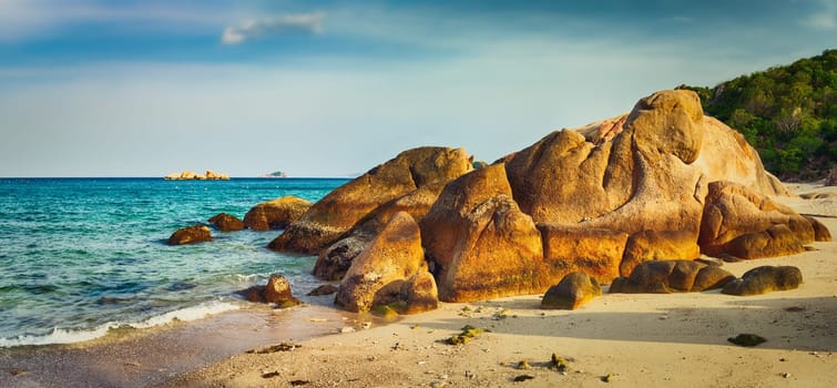 Beautiful white sand beach. Stones on a foreground. Landscape of Vietnam. Panorama