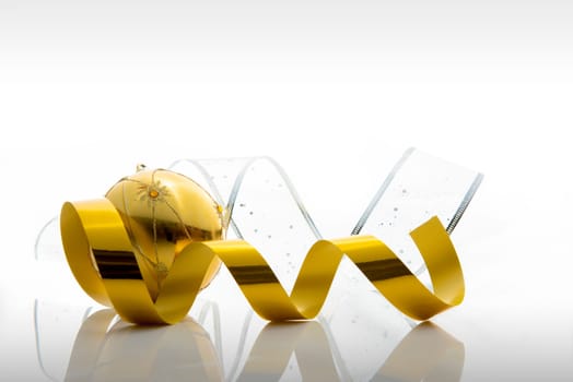 Ribbon and gold christmas ball. Christmas ornaments isolated over white background