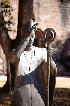 Worms, Germany - October 13, 2018: The bronze statue of Bishop Burchard in front of the St. Peter's Cathedral on October 13, 2018 in Worms..