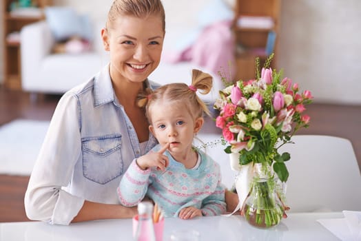 Young mother and her little daughter at home