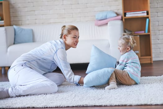 Happy female playing with adorable girl