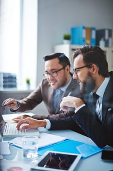 Asian businessman presenting business project to partner