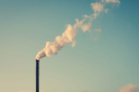 Factory chimney with white smoke