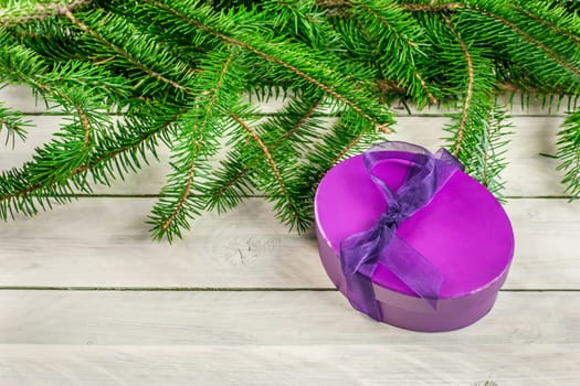 Gift box on a bright wooden background