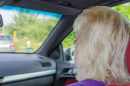Relaxed blonde passenger on a car ride
