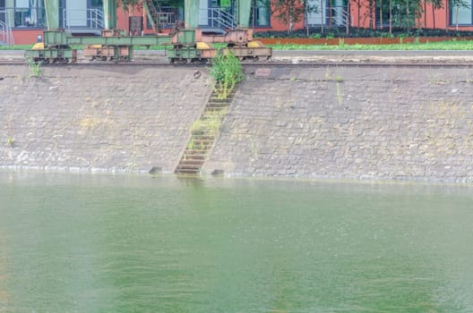 Sloping quay wall,pier with stairs in the harbour basin