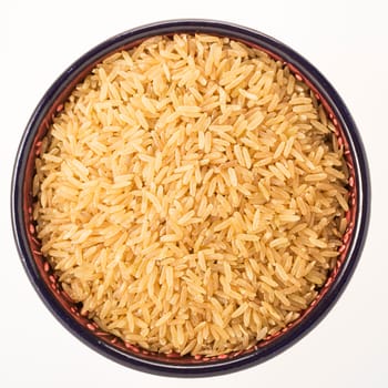 Brown rice in bowl isolated on white background