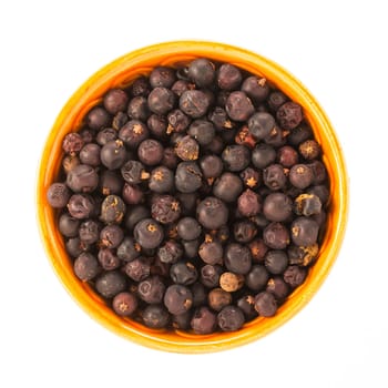 Juniper berries in bowl isolated on white background.