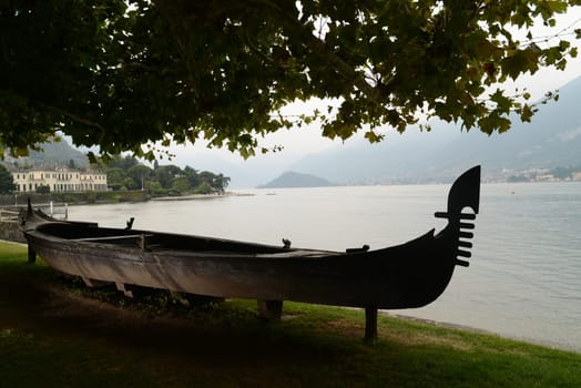 Old gondola in the gardens of Villa Melzi, one of the most beautiful tourist attractions in Bellagio (Lake Como, Lombardy, Italy).