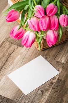Beautiful bouquet of pink tulips and congratulations on the table