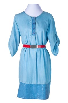 Woman spring summer dress. women's blue jeans denim dress with a red belt on a mannequin isolated on a white background. Jeans fashion. Party and cocktail dresses.