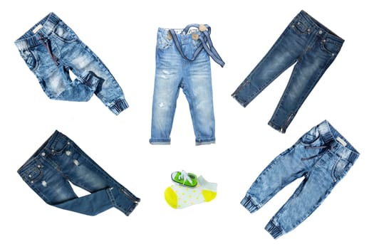Collection jeans clothes on white background. Collection of blue jeans pants for boys isolated on a white background. Childrens spring and summer fashion.