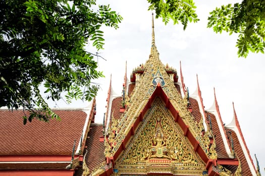 Architectural detail from exterior view of the Buddhist temple in Damnoen Saduak Floating Market near Bangkok, Thailand .