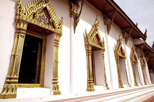 Architectural detail from exterior view of the Buddhist temple in Damnoen Saduak Floating Market near Bangkok, Thailand .