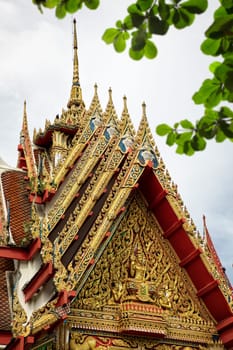 Architectural detail from exterior view of the Buddhist temple in Damnoen Saduak Floating Market near Bangkok, Thailand .