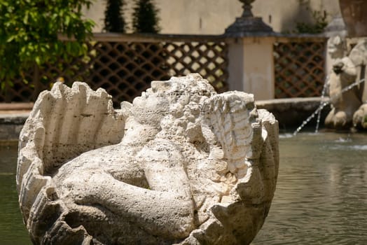 Particular of a fountain, angel statue, in Tivoli, Italy