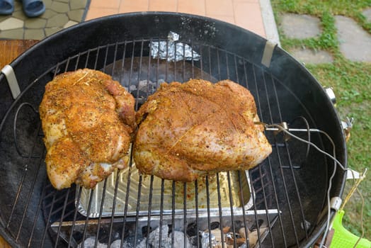 Pulled pork cooking and grilling inside a barbecue