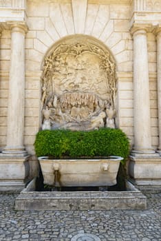 An old fountain in a public square in Tivoli, Italy