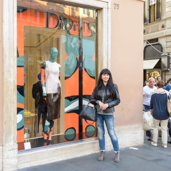 Rome, Italy - November 07, 2015: A nice girl posing in front of the Christian Dior shop in Navona square in Rome, Italy