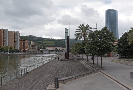 bilbao downtown with nervion river and boardwalk area, basque country, spain.