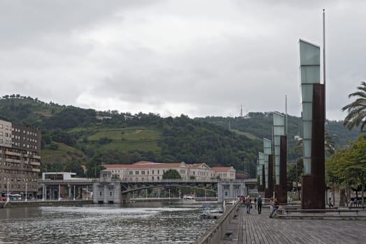 bilbao downtown with nervion river and boardwalk area, basque country, spain.