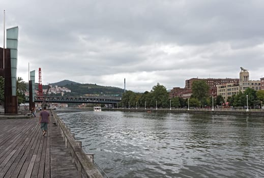 bilbao downtown with nervion river and boardwalk area, basque country, spain.