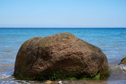 Erratic block in the surf - Baltic Sea in Schleswig-Holstein - Germany - detailed shot
