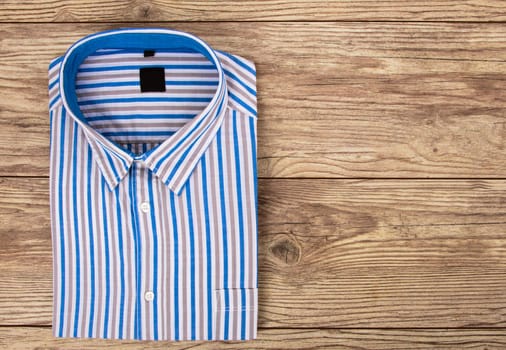 Beautiful Mens Shirt with stripes on wooden Background