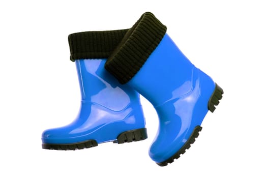 Children shoes and boots. Closeup of a pair blue rubber boots isolated on a white background. Kids shoes fashion.