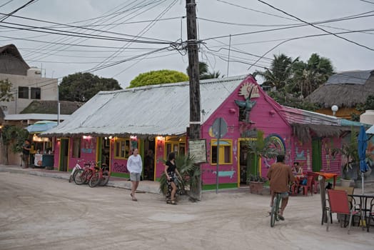 sandy road with tourists and stalls on holbox island, quintana roo, mexico located in north yucatan peninsula.