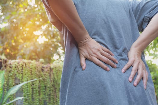 A man suffering from backache, spinal injury and muscle issue problem at outdoor.