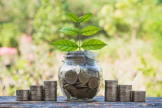 Coins in jar with money stack step growing money, Concept finance business and saving investment.