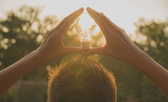 Person holding light bulb for idea or success or solar energy