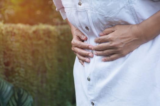 Male suffering from stomachache pain,A man stomachache at outdoor,Healthy concept.