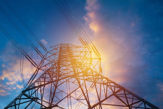 High voltage pole on blue sky background. High voltage tower.